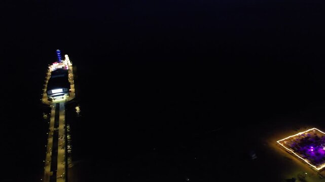 High Angle Night Footage of Illuminated Buildings and Roads with Traffic at Best Tourist Attraction Destination of England at Bournemouth City with Sandy Beach and Ocean of Great Britain, 