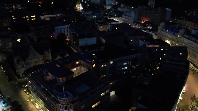 High Angle Night Footage of Illuminated Buildings and Roads with Traffic at Best Tourist Attraction Destination of England at Bournemouth City with Sandy Beach and Ocean of Great Britain, 