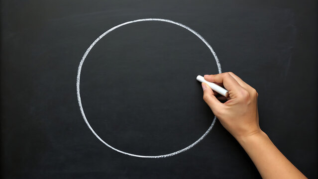Hand drawing perfect white circle on blackboard for presentation or design concept