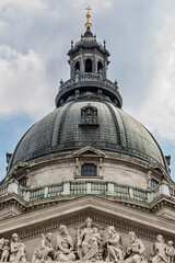 Dome of Saint Stephen's Basilica above a pediment relief of crowned figures in Budapest, Hungary, Europe © GuillaumeAngleraud