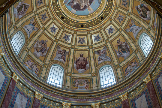 Central mosaic of Christ enthroned surrounded by angels within the gilded dome ceiling of Saint Stephen's Basilica in Budapest
