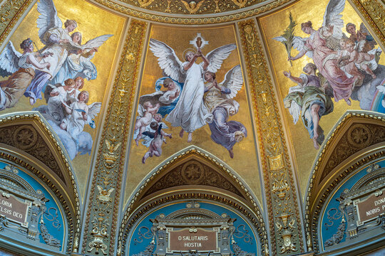 Gilded mosaic of musician and adoring angels above Latin devotional inscriptions inside Saint Stephen's Basilica