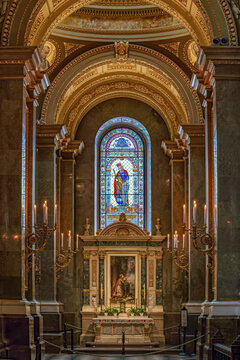 Altar of Saint Emeric with a stained glass king and a devotional painting inside Saint Stephen's Basilica