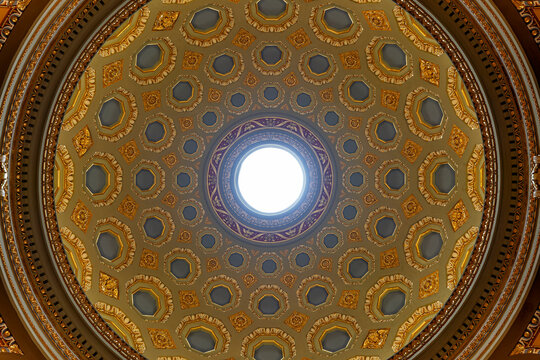 Geometric coffered dome ceiling radiating toward a central oculus inside Saint Stephen's Basilica in Budapest