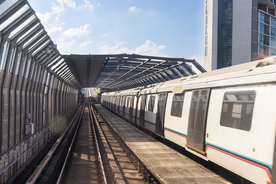 Mass rail transit train passing through tracks with sound barrier in the city of Kuala Lumpur. Sound barrier tunnels are designed to minimize noise pollution to surrounding area.