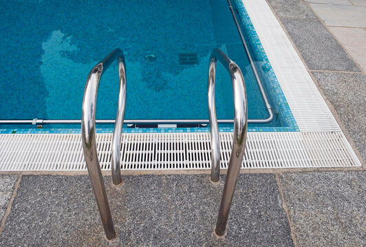 Swimming pool ladder on the poolside
