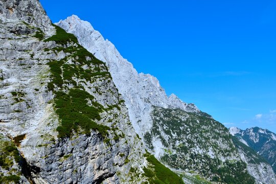 Steep mountain landscape with Prisojnik peak above Krnica valley in Julian Alps, Gorenjska, Slovenia