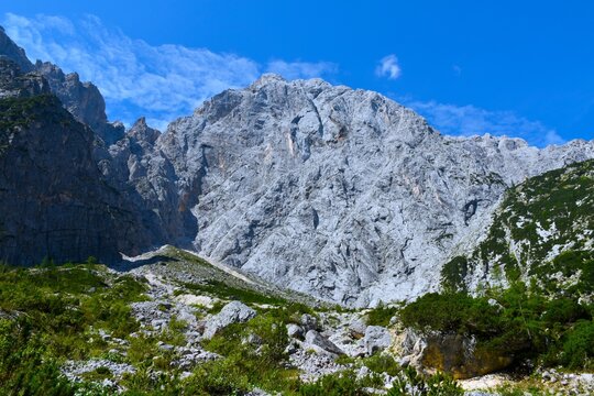 EMountain landscape with rocks and bushes bellow steep rock cliff of Prisojnik mountain in Julian alps, Gorenjska, Slovenia