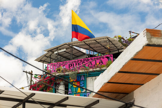 Medell&iacute;n, Antioquia, Colombia - June 29, 2026 - View of a tourist lookout in Comuna 13, San Javier, featuring urban architecture, art, and a Colombian flag waving in the iconic neighborhood
