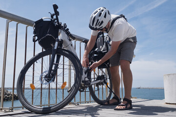 Fototapeta premium Cyclist Locking His Bicycle to a Metal Railing for Security