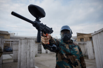 Fototapeta premium A portrait of well-armed and clothed soldier, holding a military gun in his hand