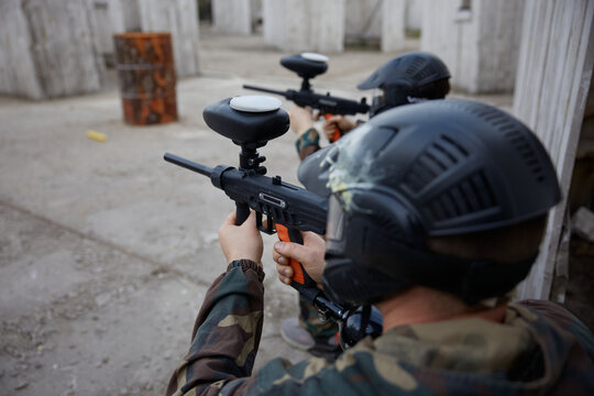 Two soldiers point their guns at a target on a training field