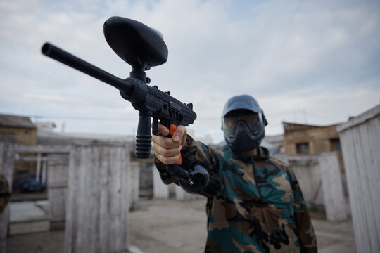 A portrait of well-armed and clothed soldier, holding a military gun in his hand