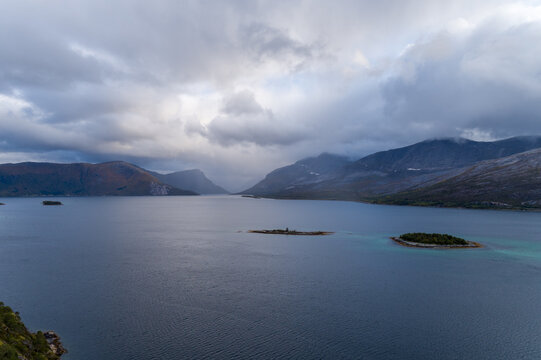 Mountainous Efjord and small islands under storm clouds