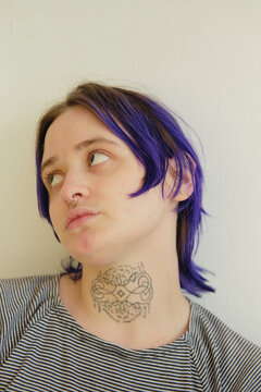 Closeup portrait of a non-binary person looking away