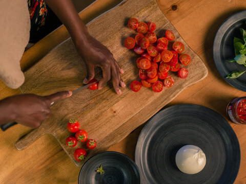 Woman cutting.cherry tomatoes 