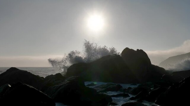 Arma&ccedil;&atilde;o Beach in Florian&oacute;polis, Brazil. Backlit Waves Crashing Against Coastal Rocks in Slow Motion. Aerial View.