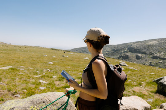 Woman in athletic wear admiring the natural scenery during a hike