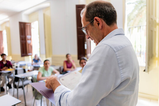 Teacher addressing students in a classroom during a lesson