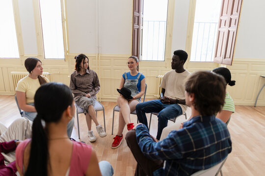 Diverse young adults engaging in group discussion