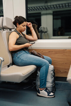 Woman using phone on train