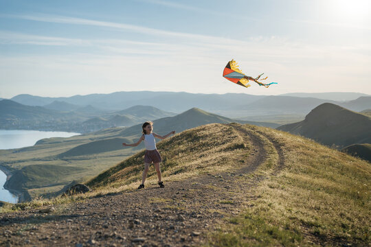  Little girl with flying kite