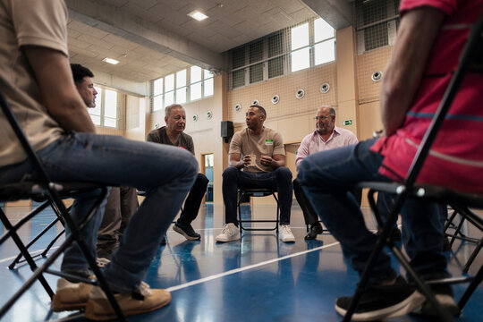 Diverse men connecting in support group discussion