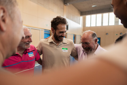 Diverse men smiling and participating in team building activity