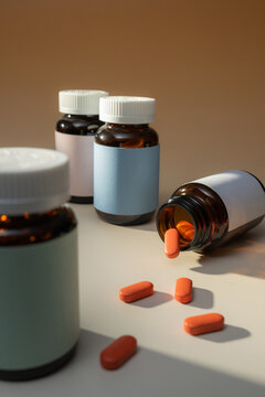 Amber glass pill bottles with orange tablets