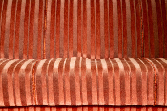 The striped surface of a velvet sofa