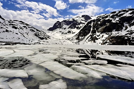 Ice floes float in the half-frozen Upper Murgsee, Murgtal, Canton of St. Gallen, Switzerland