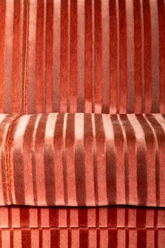 The striped surface of a velvet sofa