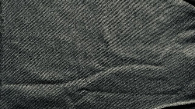 charcoal knit fabric texture macro draped in soft folds as moody minimal backdrop for web banner and textile branding