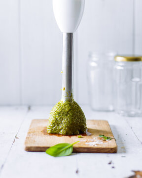 Blending pesto in a kitchen with fresh ingredients