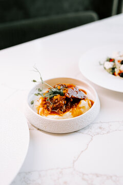 Braised beef with mashed potatoes in a ceramic bowl