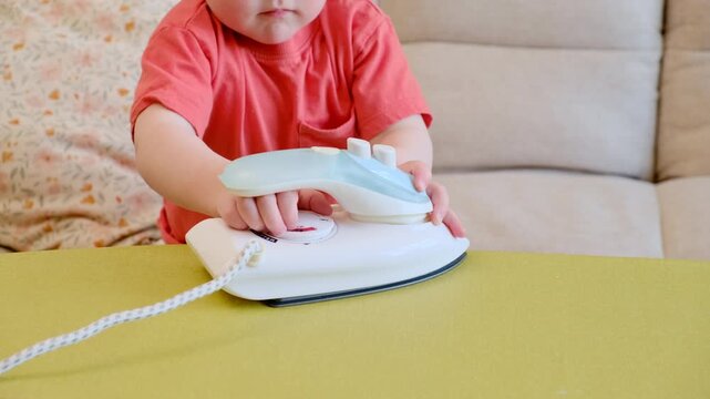 Why keeping irons out of reach is crucial to protecting curious children. Child learning household chores through imaginative play. Educational game for preschooler developing life skill at home