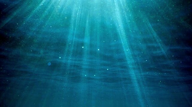 Sunlight rays shining through ocean surface. Real video of View from underwater Sea. Seamless loop of deep blue ocean waves from underwater background, Light rays Shining through rays. Slow motion.