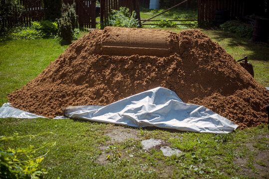 pile of sand offloaded in a backyard