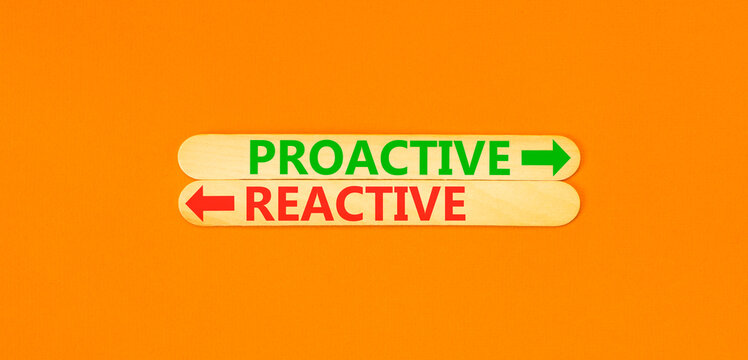 Proactive and reactive symbol. Concept word Proactive Reactive on beautiful wooden sticks. Beautiful orange background. Business proactive and reactive concept. Copy space.