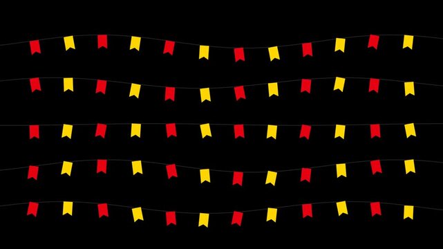 Red and yellow bunting flags hanging on strings as decorative party garlands for a festive celebration event on a dark background