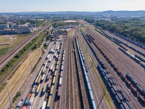 Karlsruhe, Germany - 29 July 2026: Aerial view of a large railway marshalling yard featuring numerous freight trains, intermodal containers, and extensive railway infrastructure.