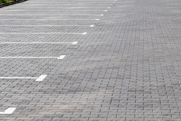 Fototapeta premium Empty parking lot with many spaces and some grass areas
