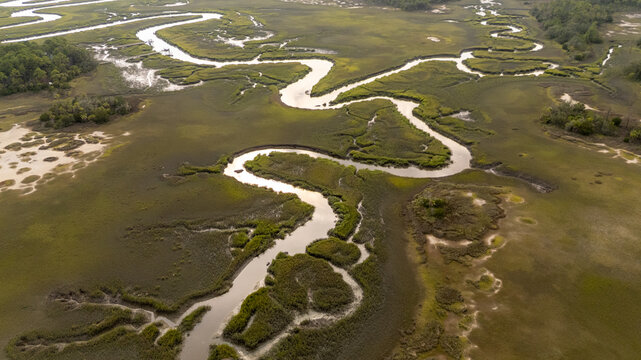 Drone view of winding waterways in the lowcountry wetlands under cloudy sky