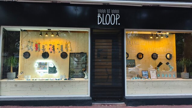 Royan, France - July 15, 2026: Charente-Maritime. Nouvelle-Aquitaine. Retail storefront of Le Bloop featuring decorative items and jewelry displayed in large windows, wooden accents and modern design