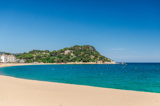 Sandy beach and turquoise bay in Lloret de Mar, Costa Brava