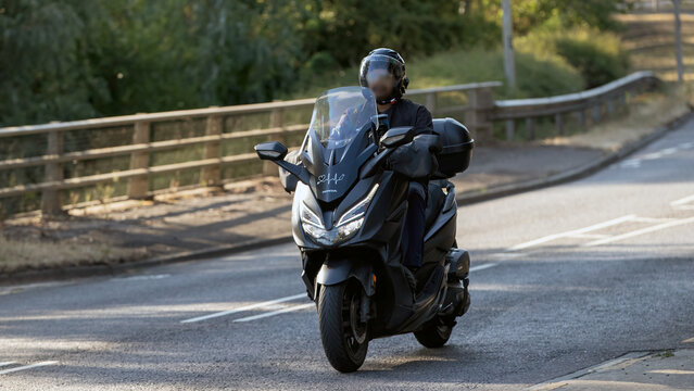 Milton Keynes,UK - Aug 12th 2026: 2021 Honda NSS 125 AD-M motorcycle driving on a British road