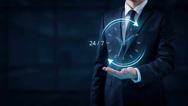 Business professional holding a glowing holographic clock icon representing twenty four seven support and customer service