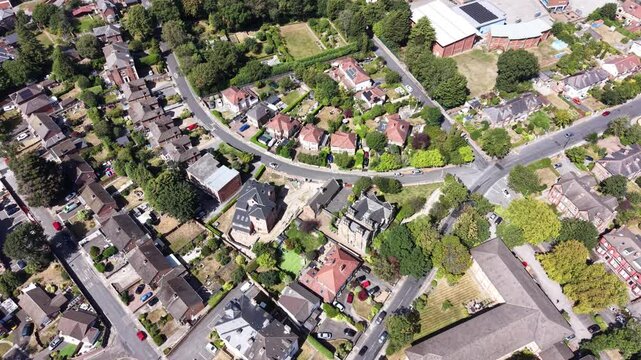 Aerial drone 4K clip showing Wirral housing blocks illuminated by warm daylight sky with bright natural highlights Wirral