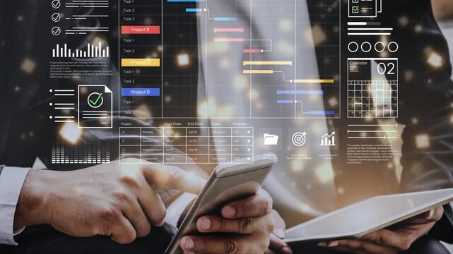 Business professional using smartphone and tablet with digital project management interface displaying performance metrics and progress tracking data visually represented in modern workspace. Entropy.