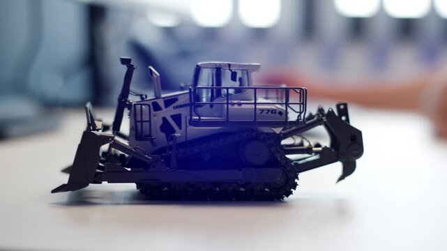 Scale model bulldozer displayed on a table indoors